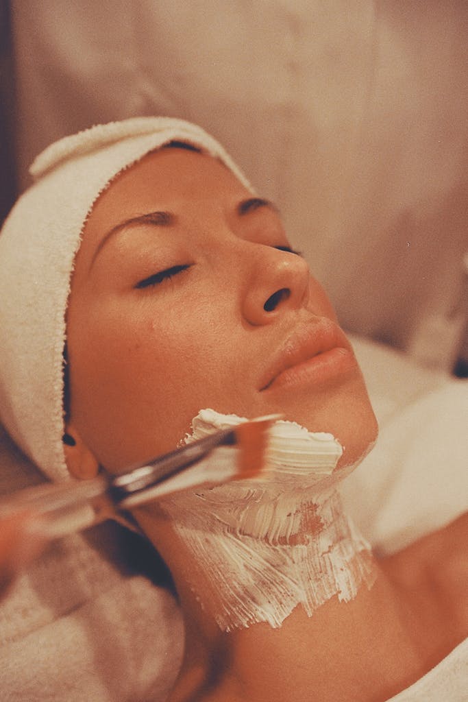 Close-up of a woman getting a soothing facial treatment at a spa for relaxation.